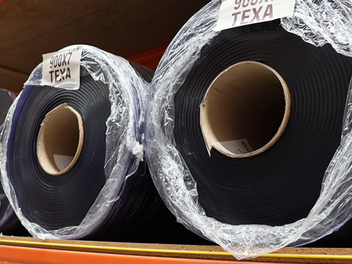 HIgh quality bulk PVC material rolls in a warehouse - High grade in black colour plastic strip